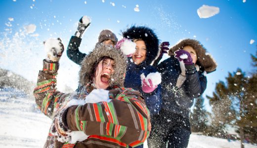 Girls having a snowball fight on a beautiful winter day